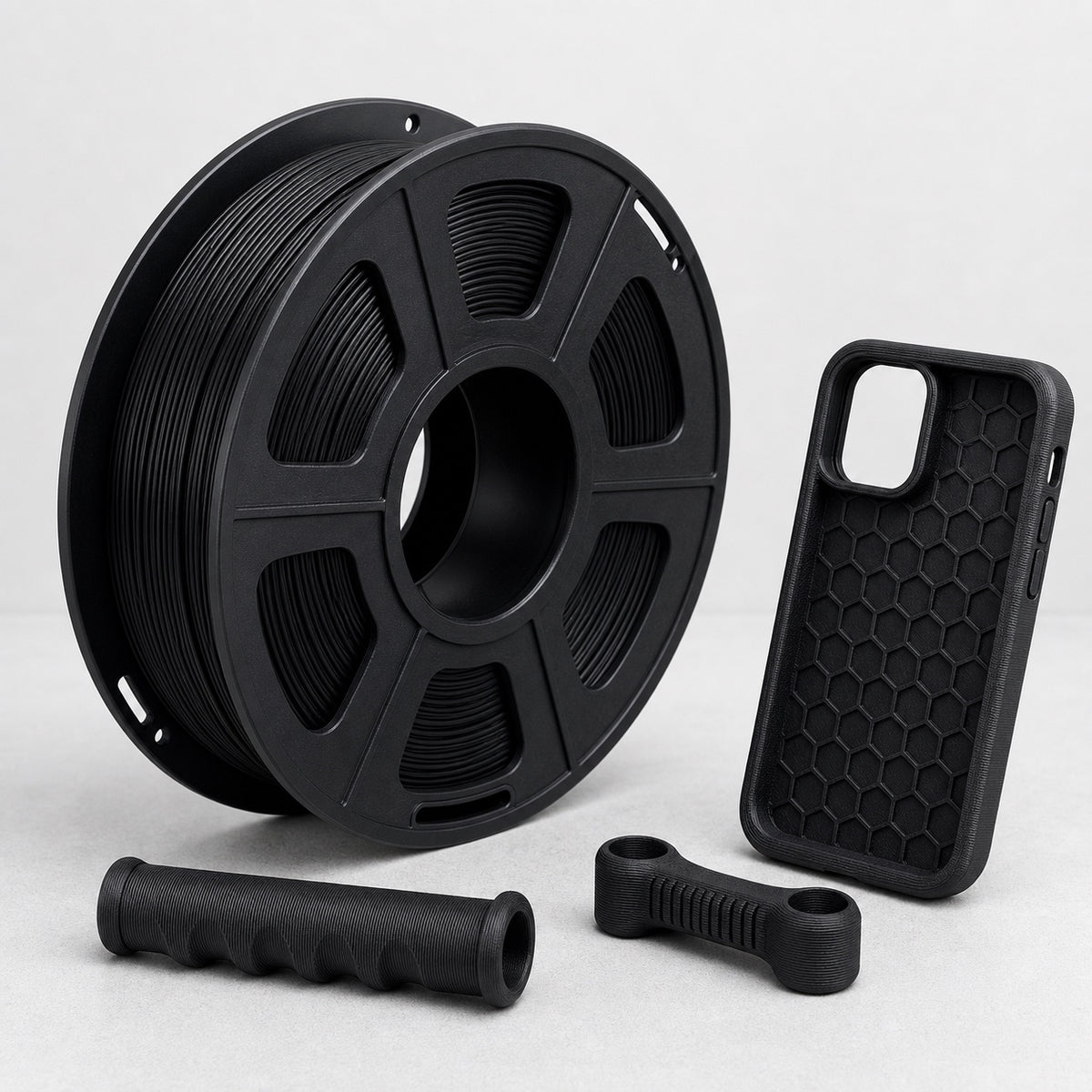 Black TPU filament spool with flexible 3D printed phone case and grips